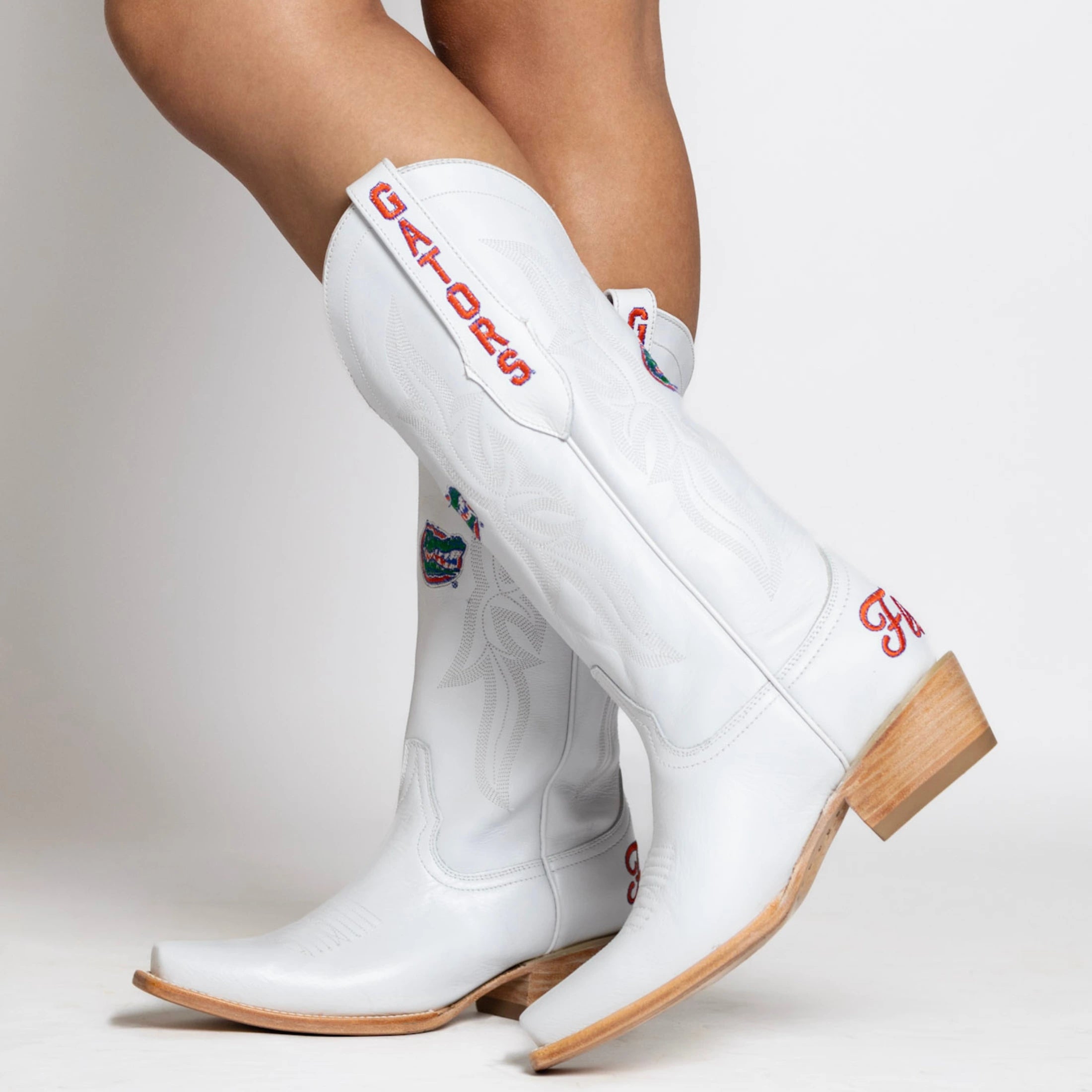 White cowgirl boot with Florida Gators logo on the shaft, gators on the pull strap, and Florida on the heel.