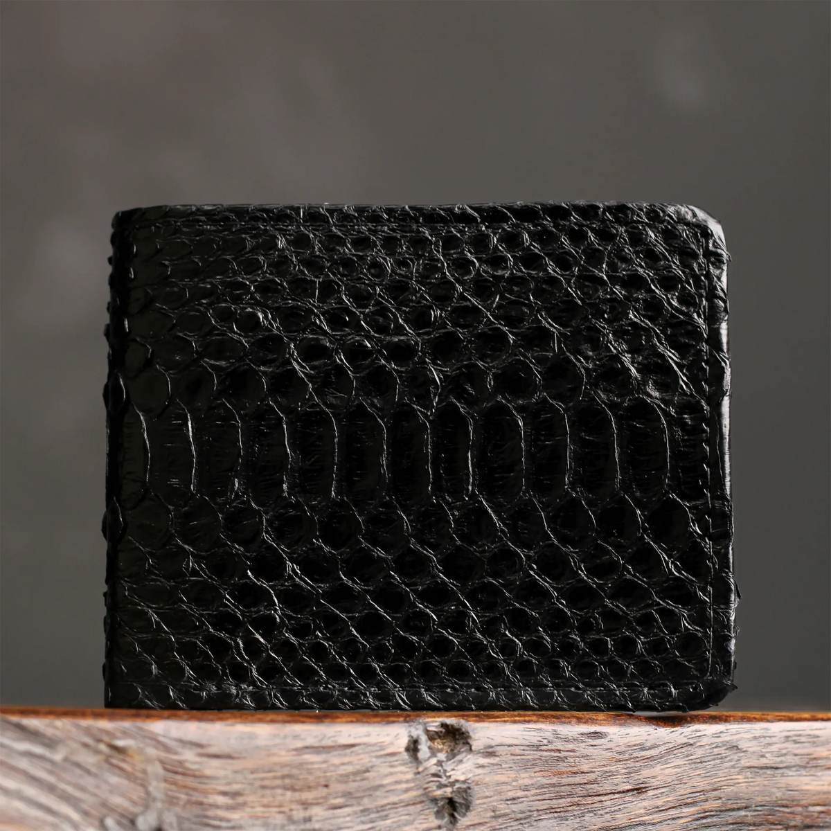 Black python billfold with close-up scale texture and stitched border