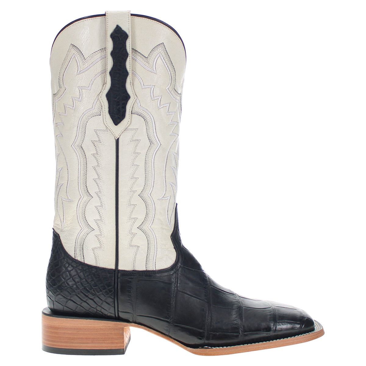 Black-and-cream cowboy boots with embroidered stitchwork and tan heel