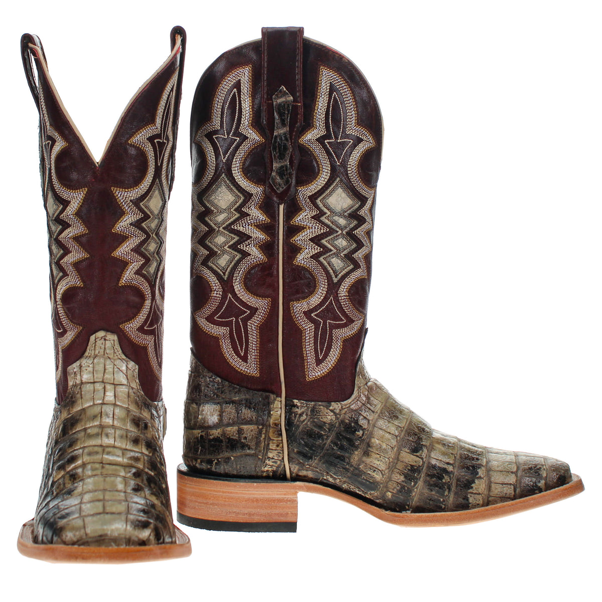 Pair of alligator cowboy boots with western embroidery and textured tan legs