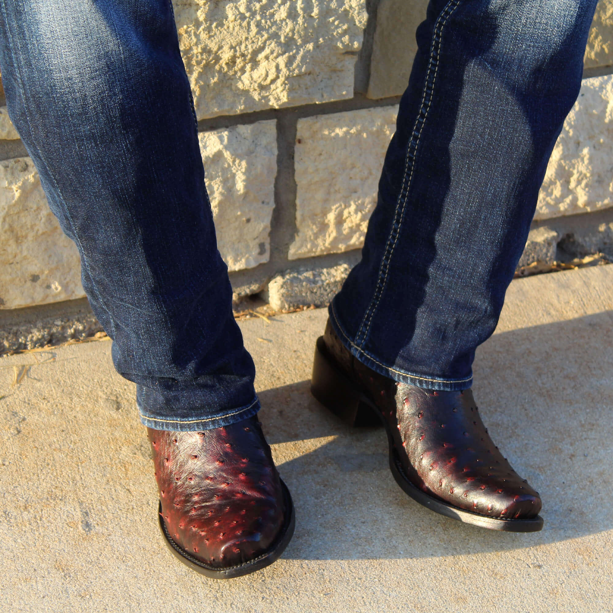 Mens black cherry leather western boots with narrow square toe and decorative stitching, featuring full-quill ostrich leather on the foot for added texture.