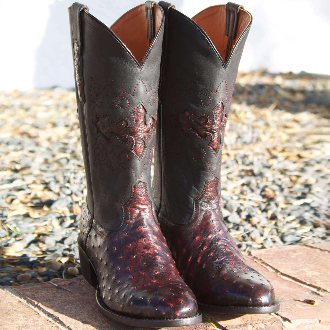 Mens black leather western boots with round toe and decorative stitching, featuring full-quill ostrich leather on the foot for added texture.