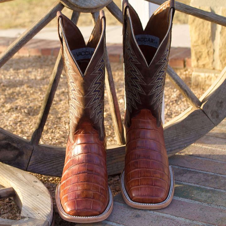 Mens black leather western boots with round toe and decorative stitching, featuring full-quill ostrich leather on the foot for added texture.