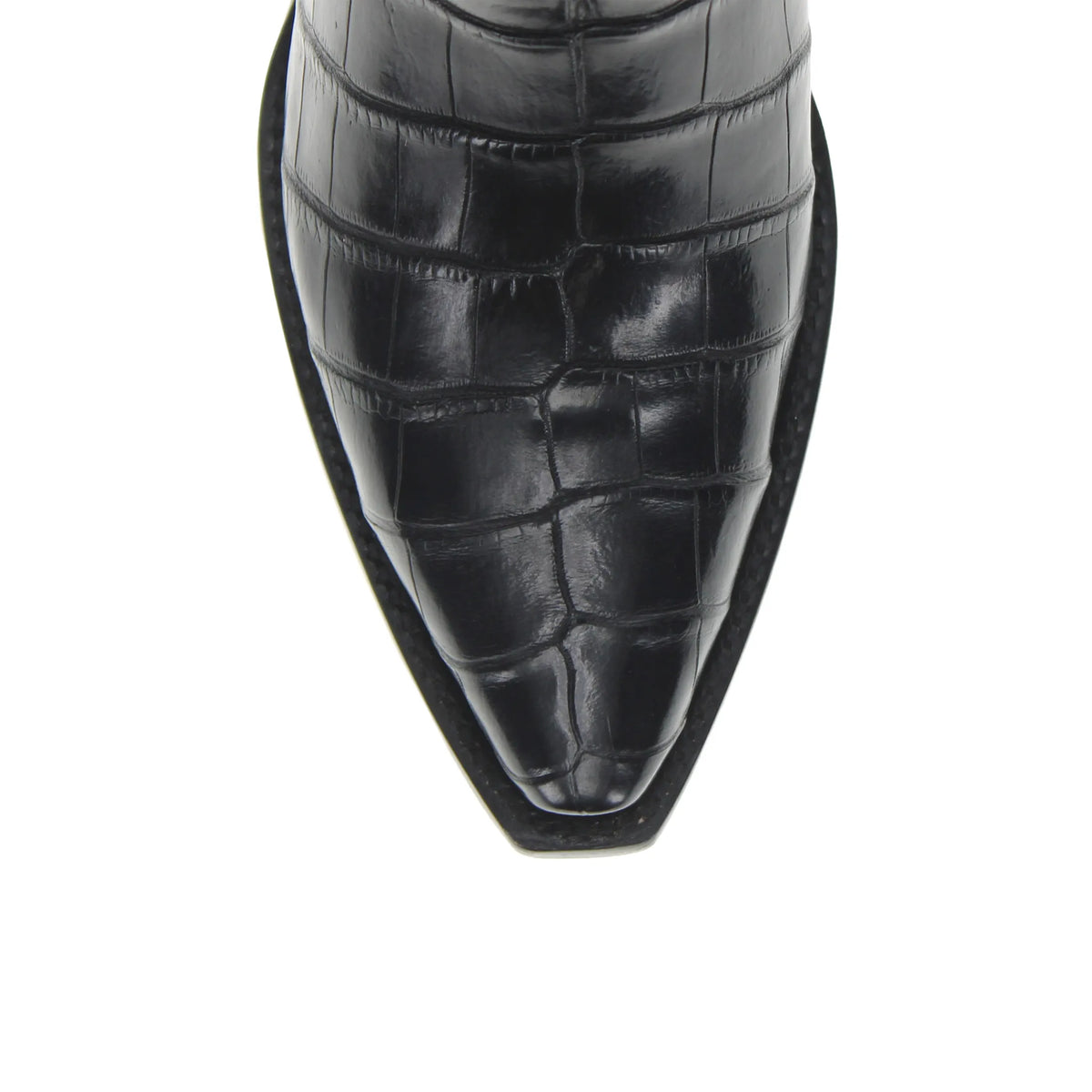 Black cowboy boot toe and vamp close-up, textured alligator belly leather