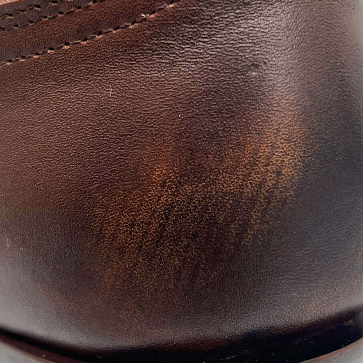 Brown leather boot heel area showing wear marks on the leather finish