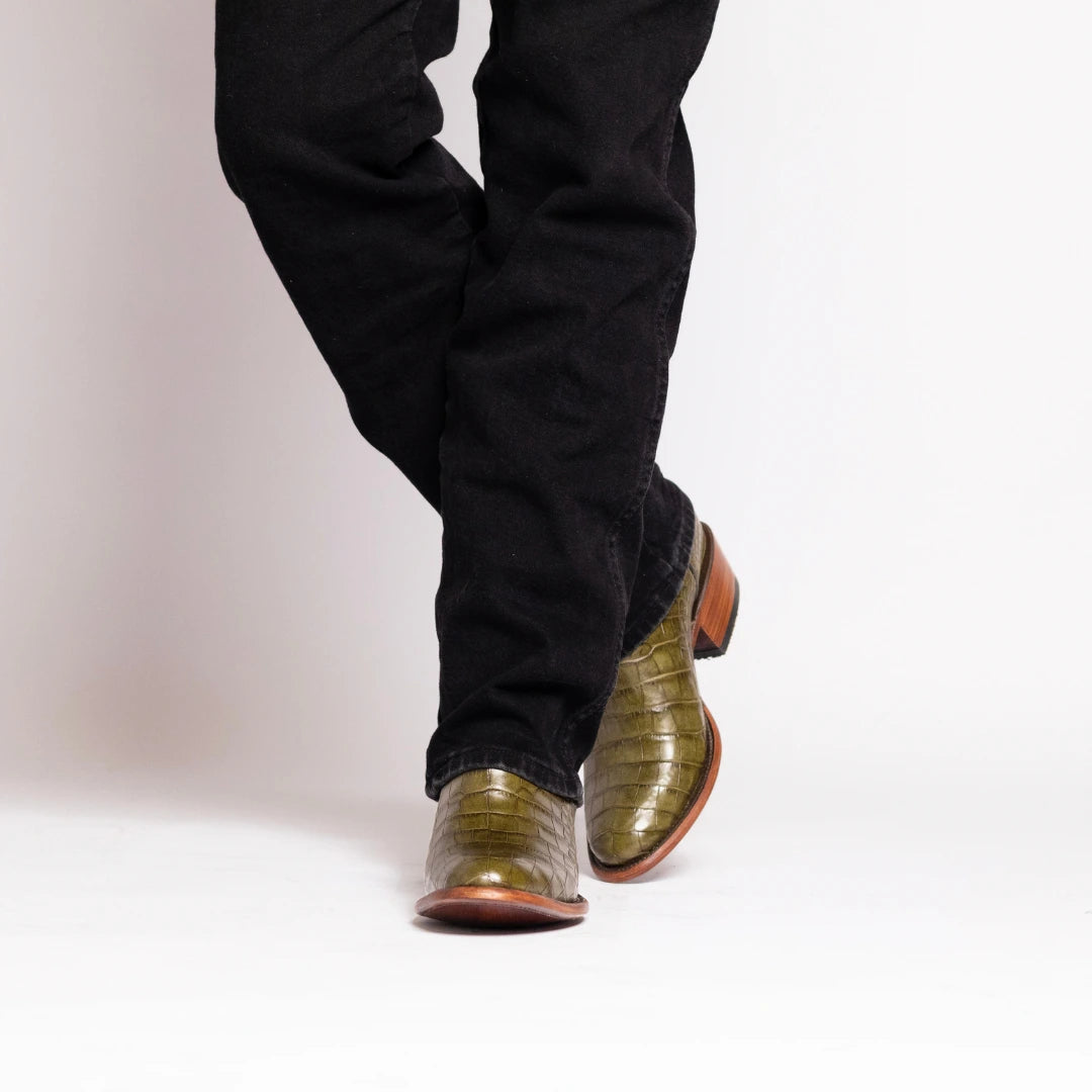 Travis western boot in textured olive leather with brown toe, with dark jeans