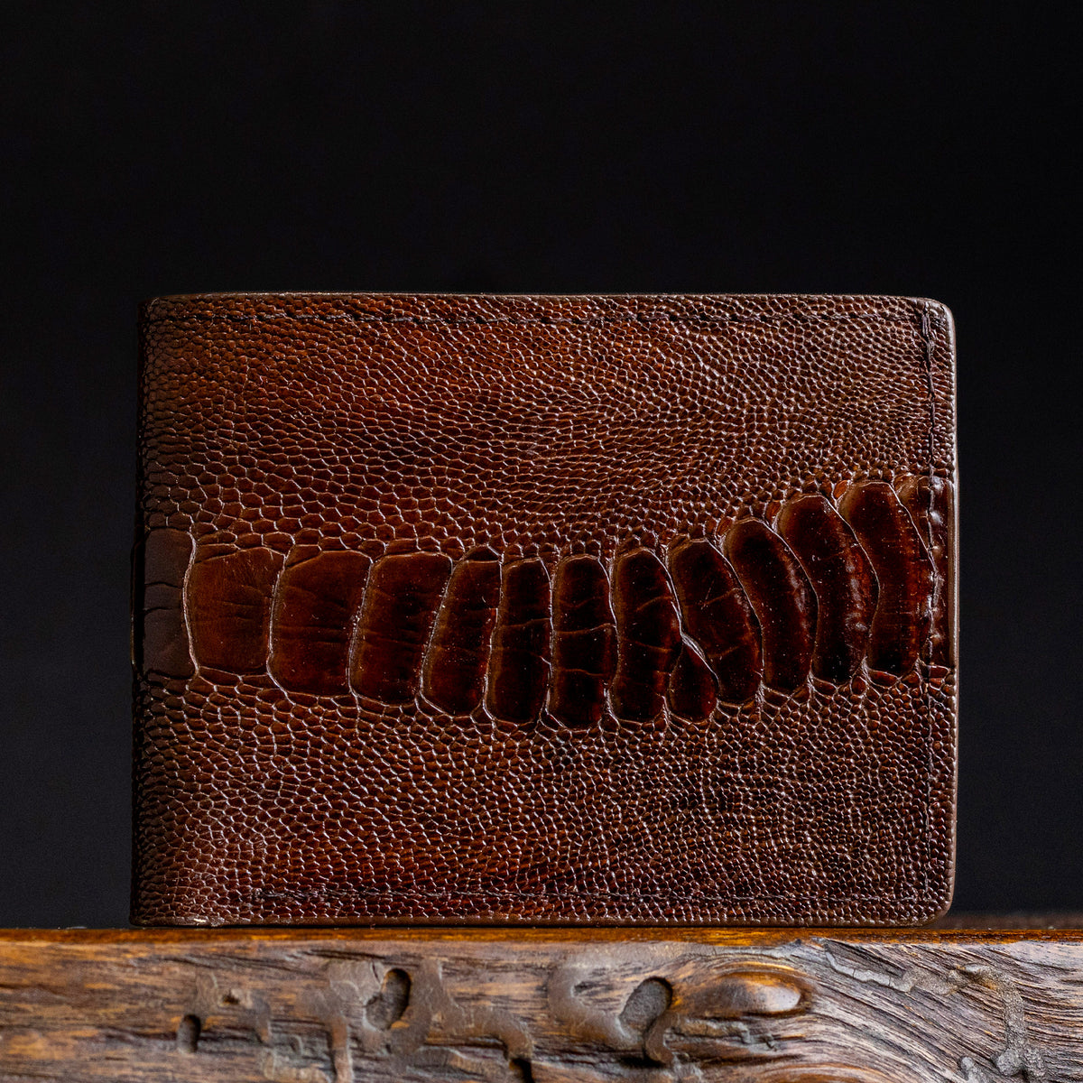 Dark brown ostrich leather billfold wallet with embossed scale texture