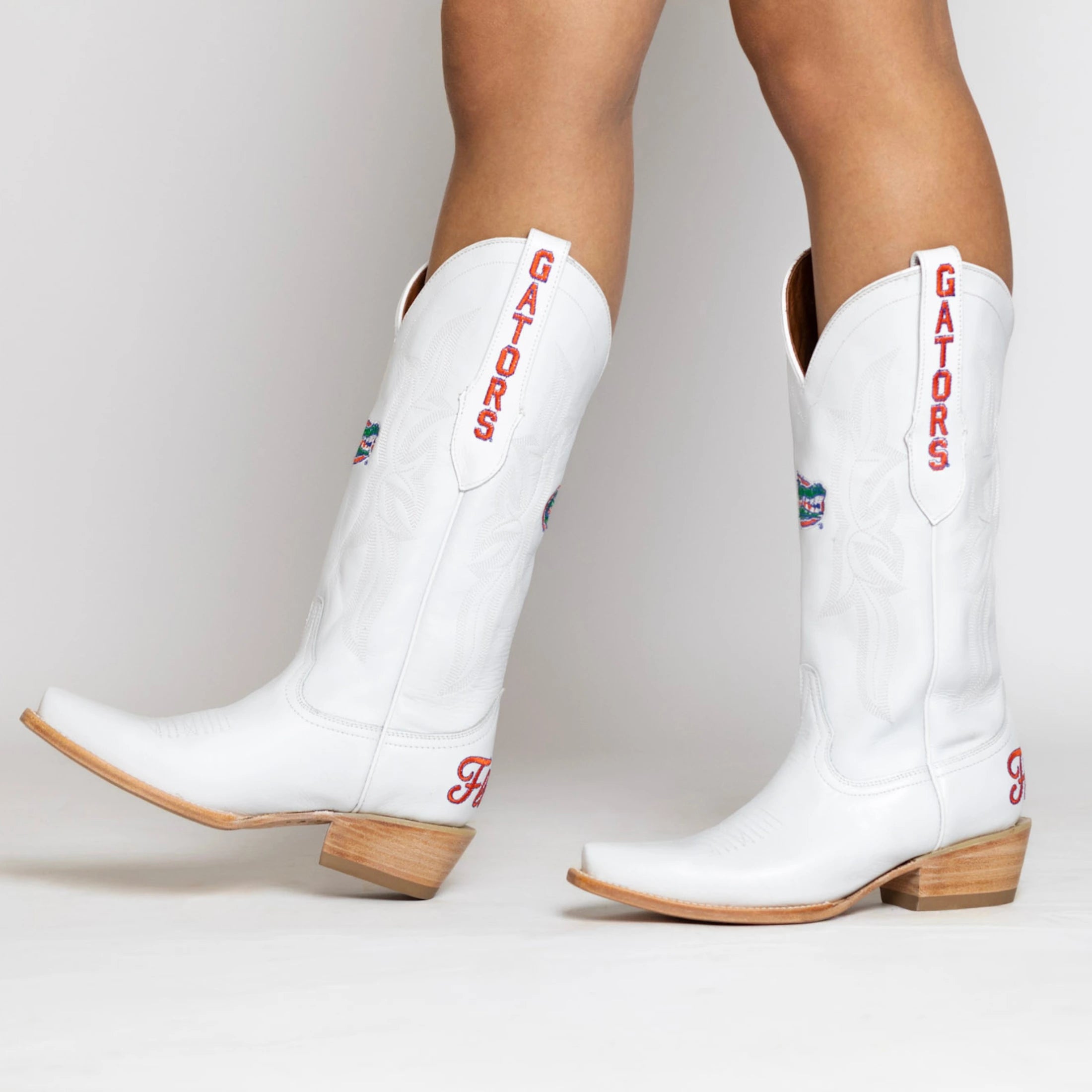 White cowgirl boot with Florida Gators logo on the shaft, gators on the pull strap, and Florida on the heel.