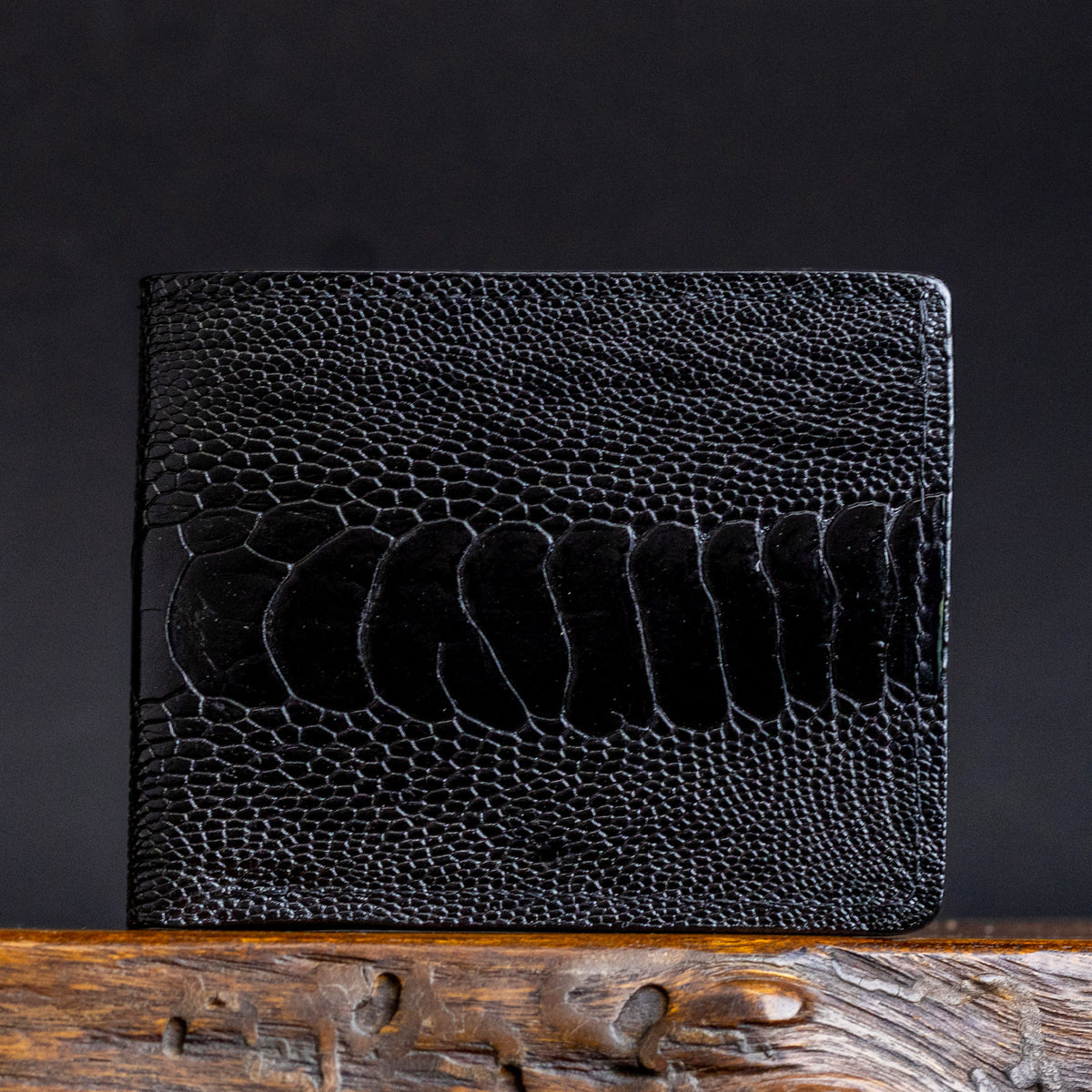 Close-up ostrich leather billfold with leg-grain texture and stitched edge