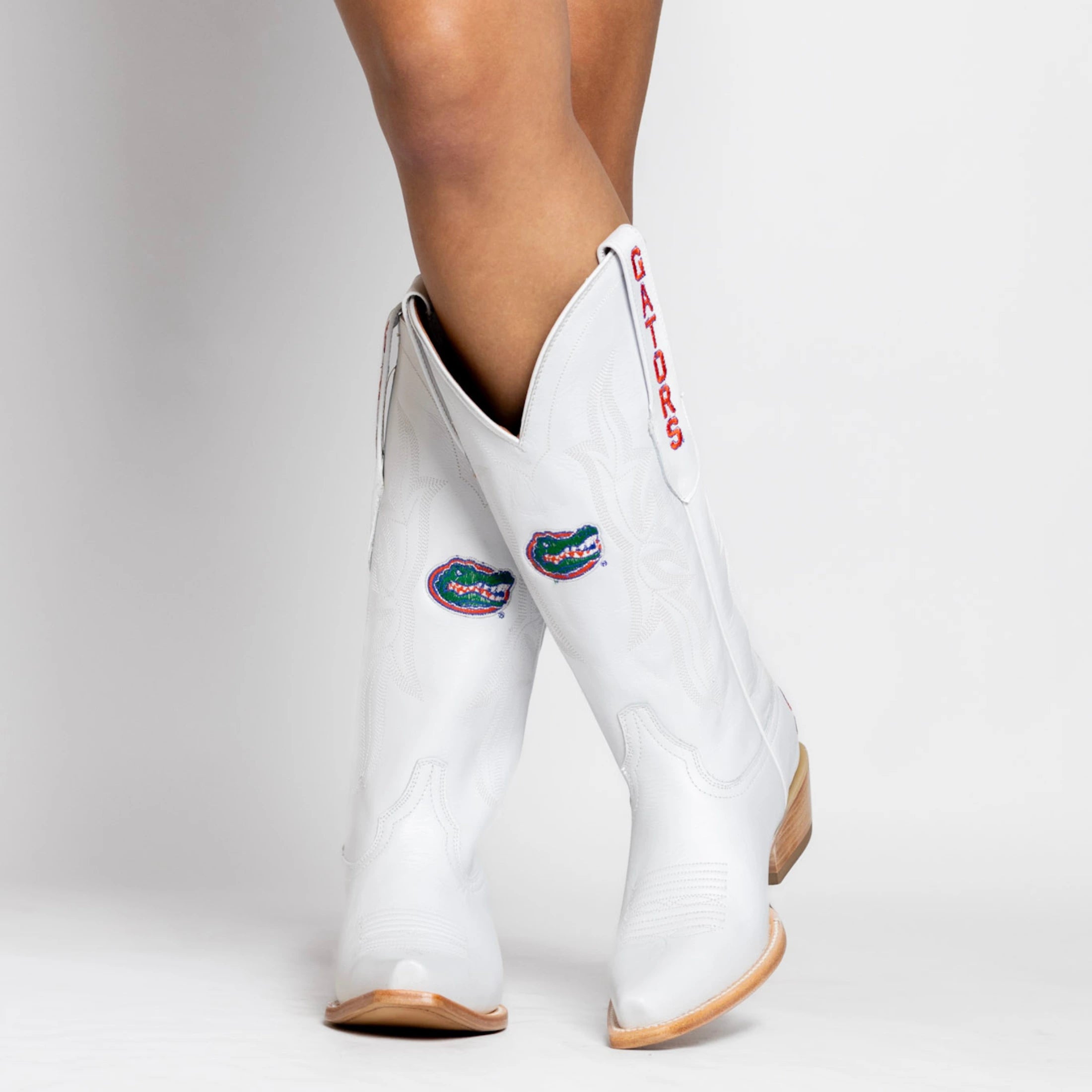 White cowgirl boot with Florida Gators logo on the shaft, gators on the pull strap, and Florida on the heel.