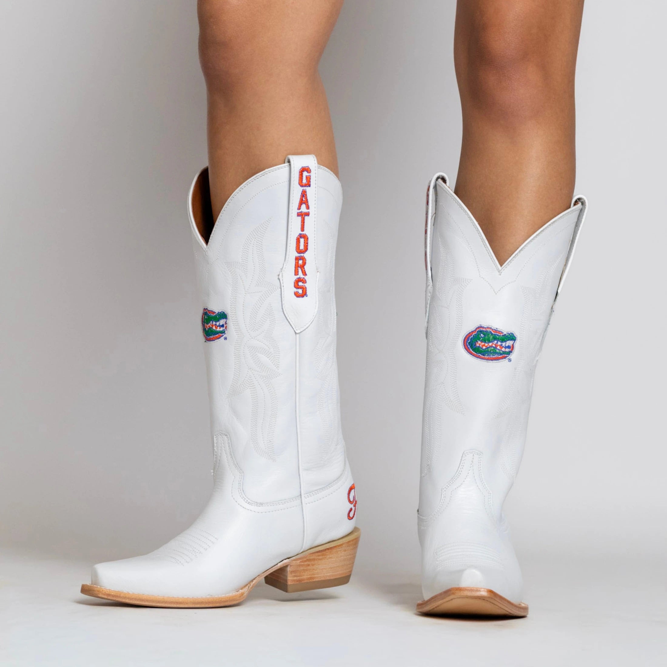 White cowgirl boot with Florida Gators logo on the shaft, gators on the pull strap, and Florida on the heel.