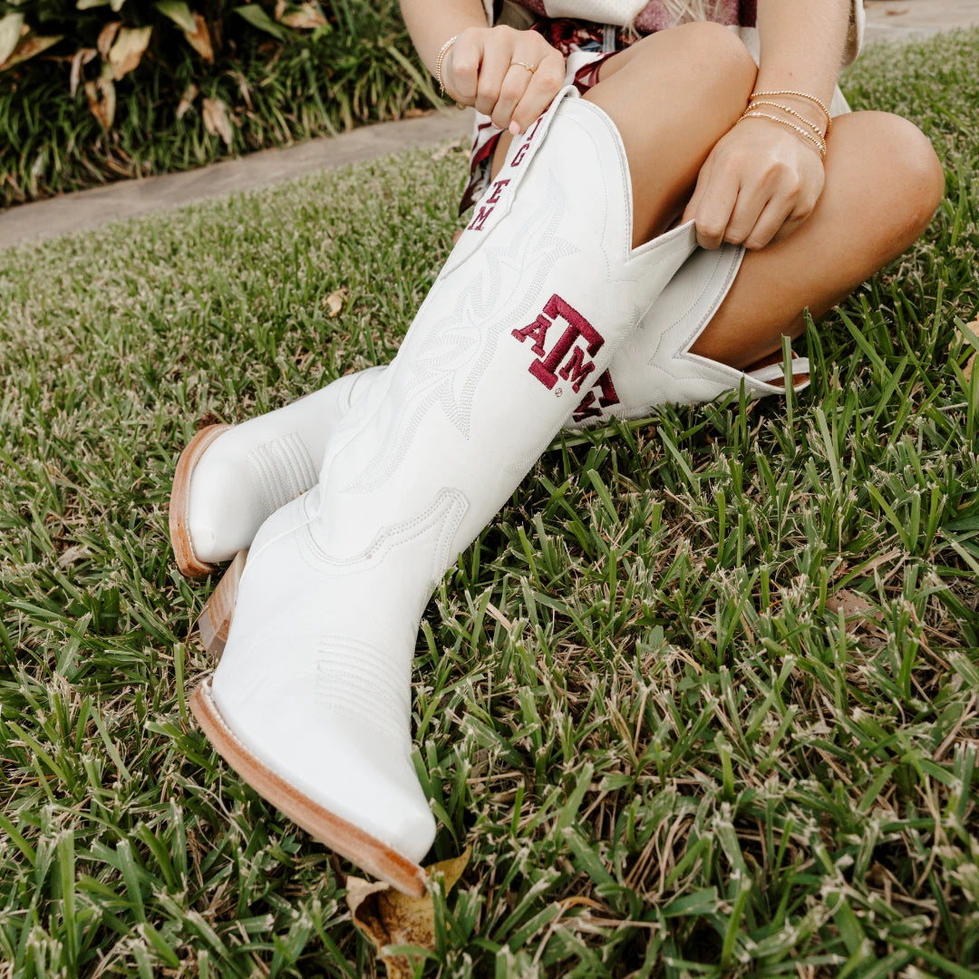 White cowboy boots with Texas A&M logo patch on side