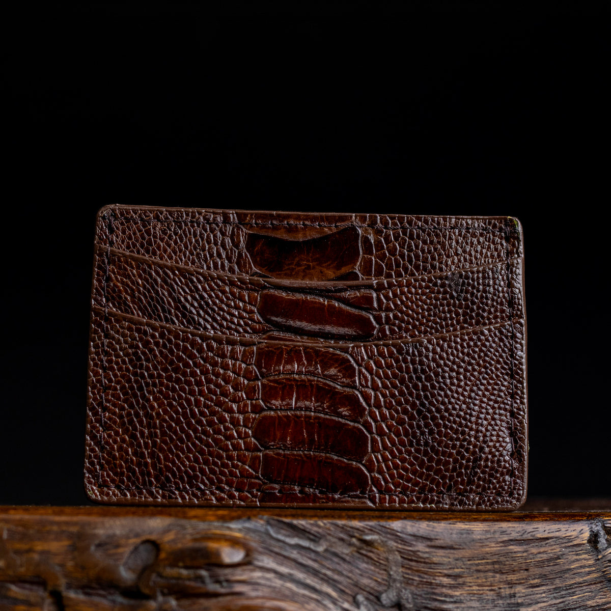 Brown ostrich leather card holder, front panel detail with stitched texture