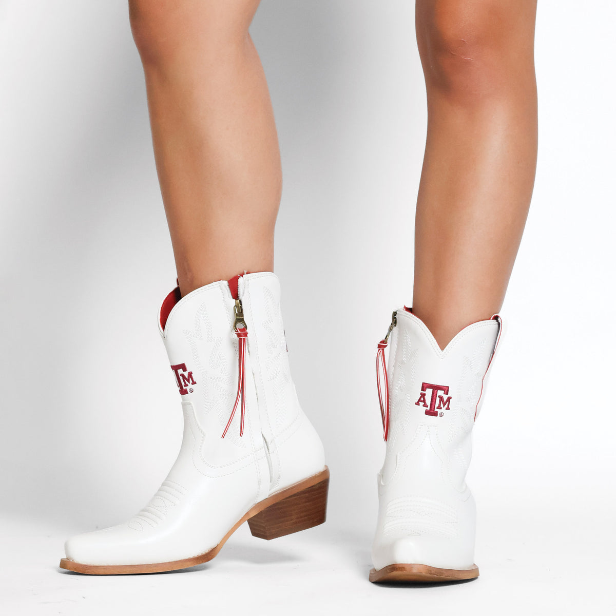 Lynn white mid-calf cowboy boots with red tassel accents and low wooden heels
