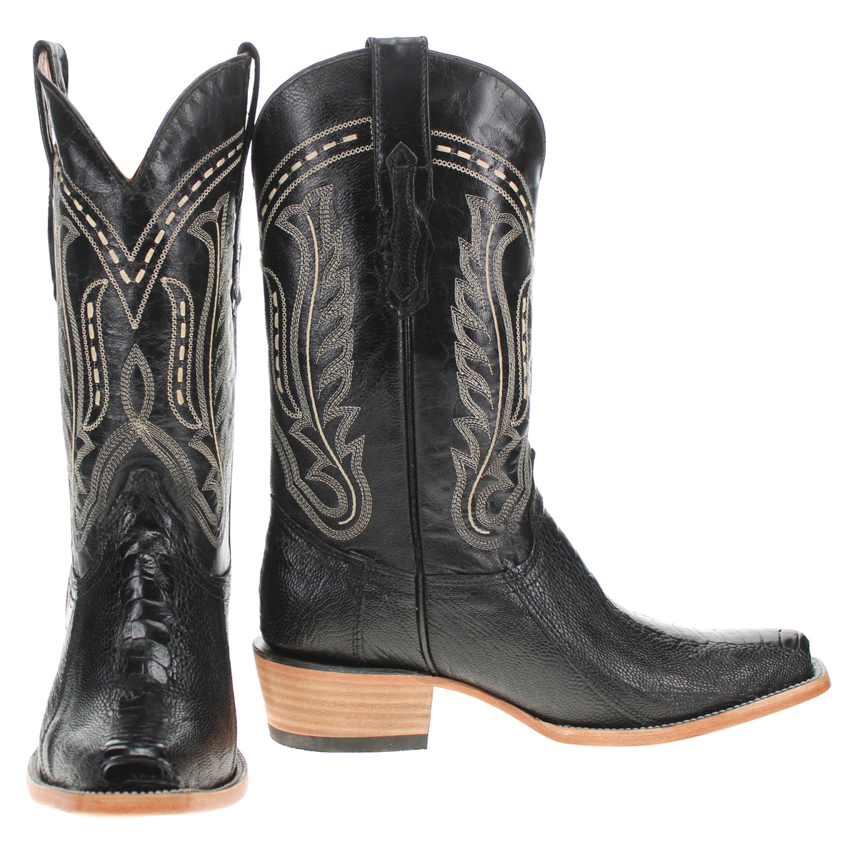 Black cowboy boots with tan sole and decorative stitched floral embroidery, side view.