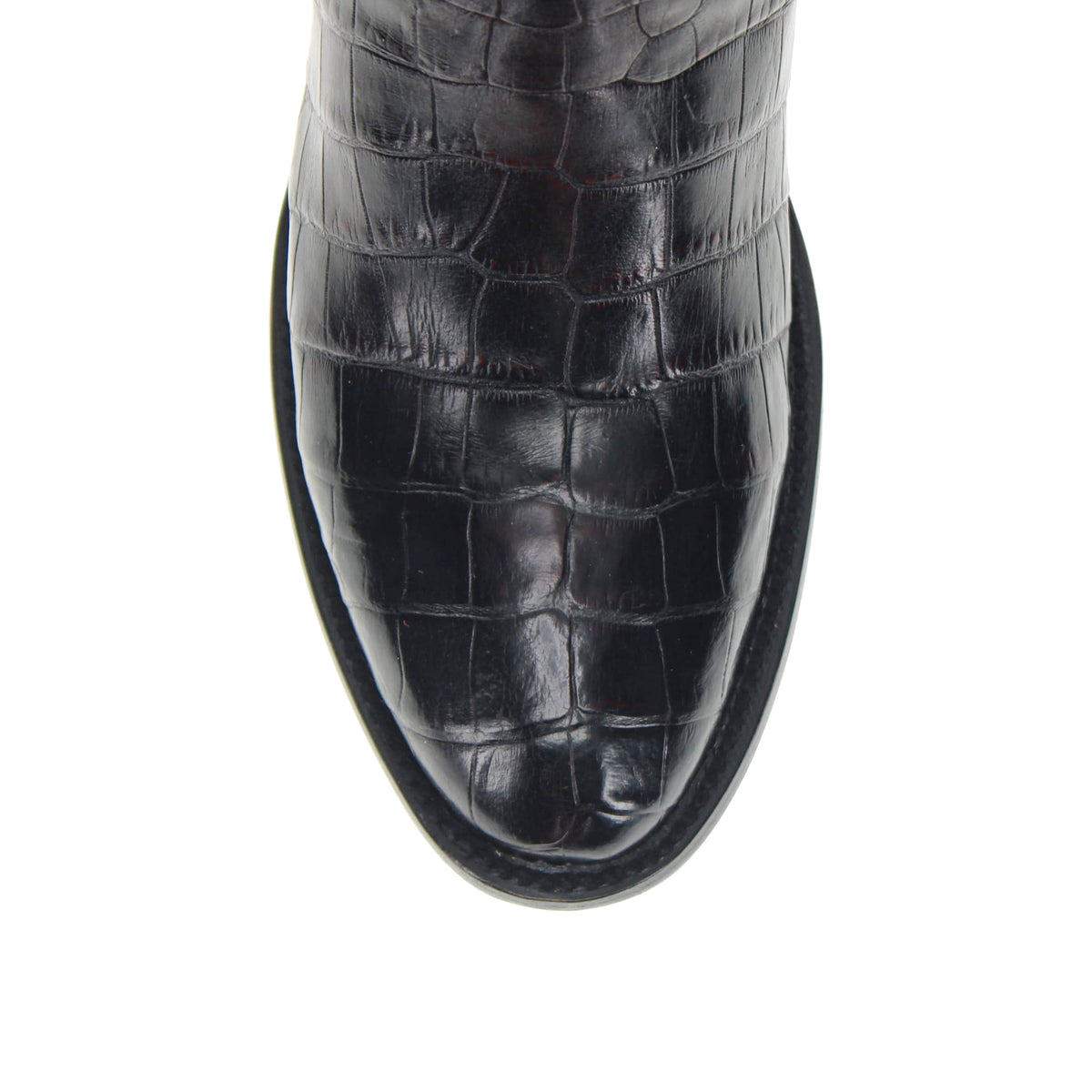 Black leather cowboy boot toe and vamp with glossy crocodile texture
