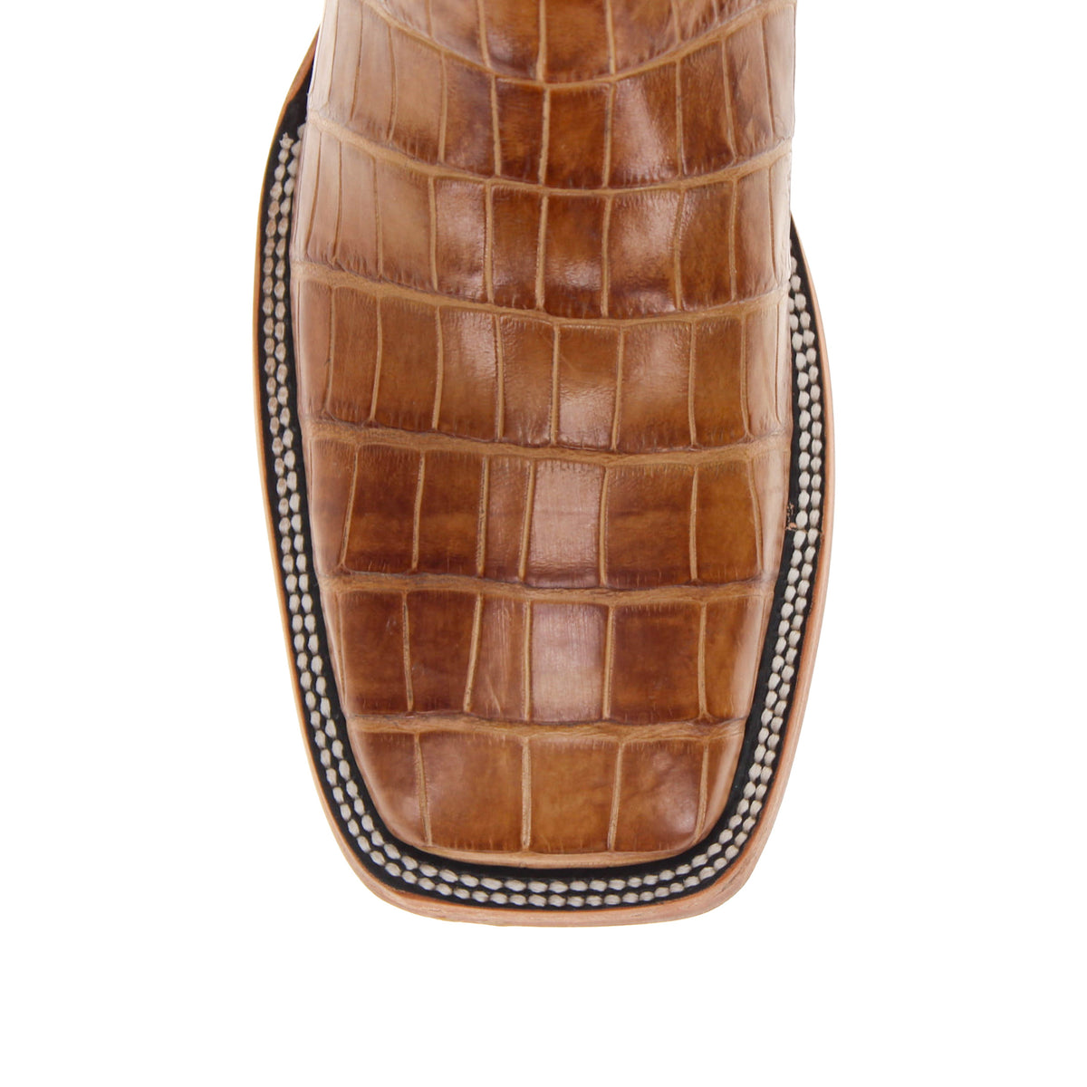 Tan croc-embossed boot vamp with stitched edge and textured leather panels