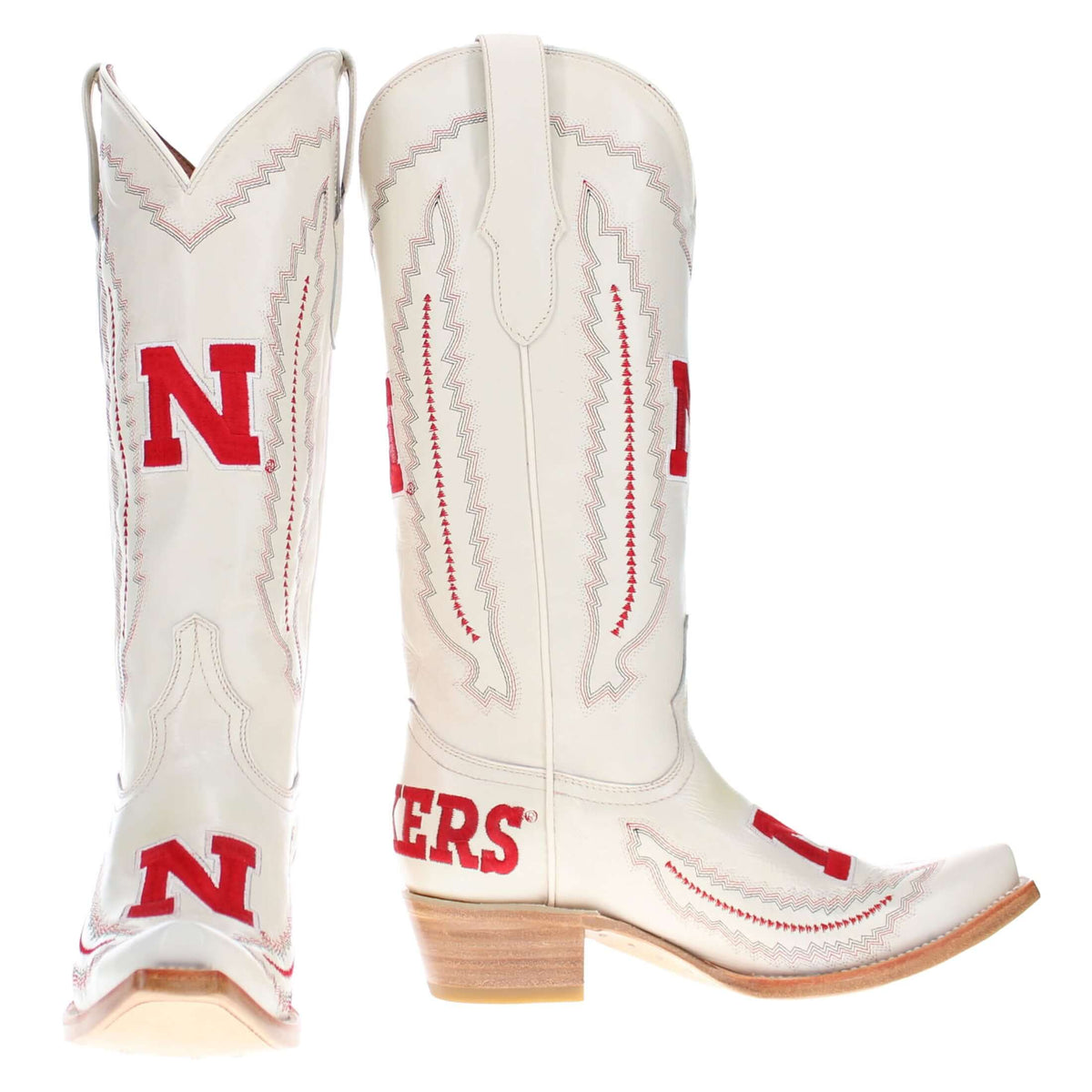 Pair of cream cowboy boots, close-up of red N logos and decorative seam stitching