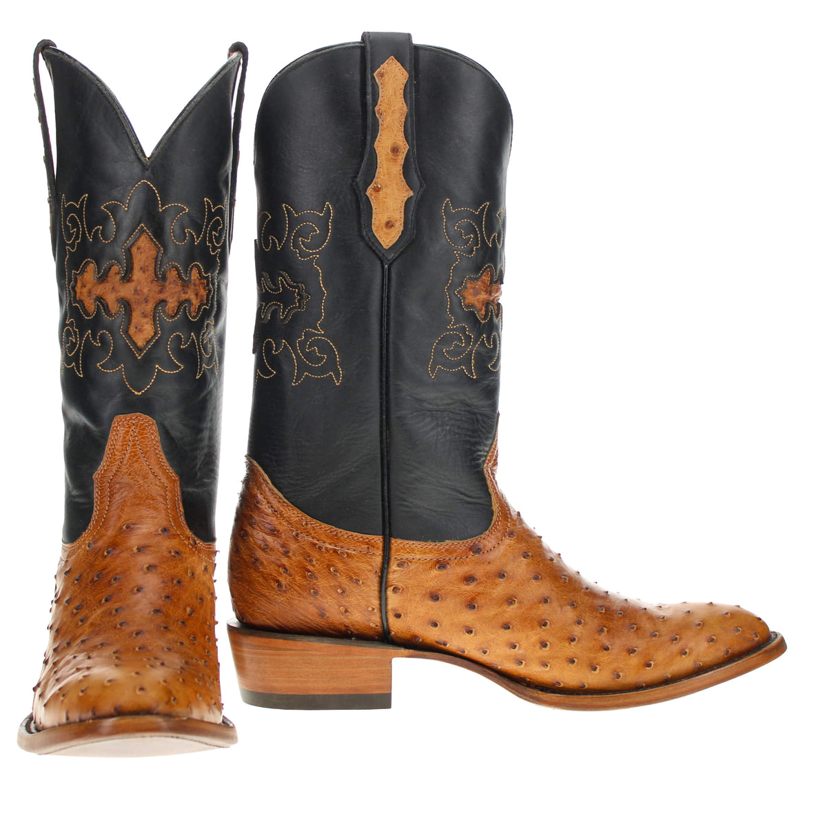 Pair of black and tan western boots with embroidered scroll design and pointed toes