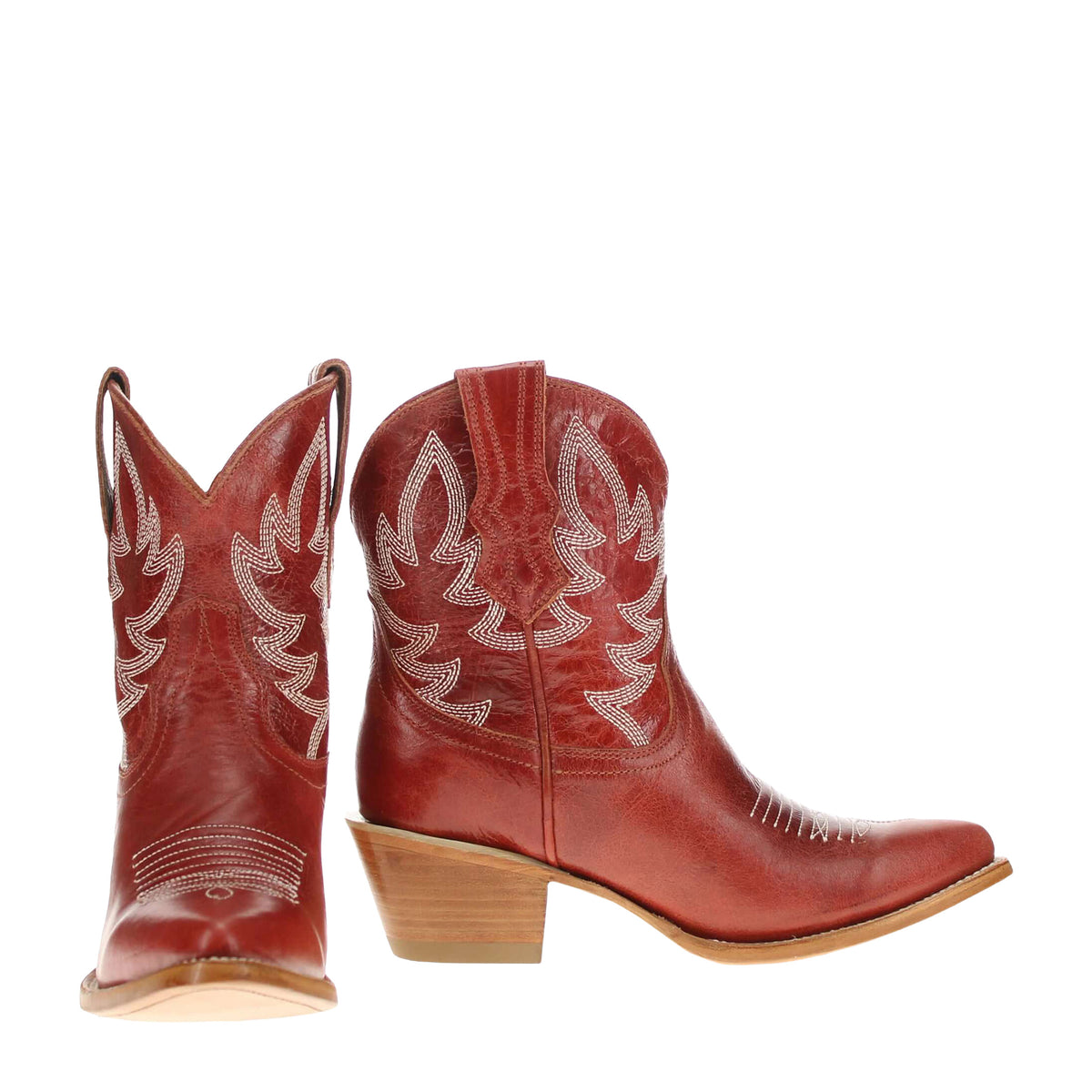 Red cowboy boots with white embroidered leaf swirl panels and stacked heel