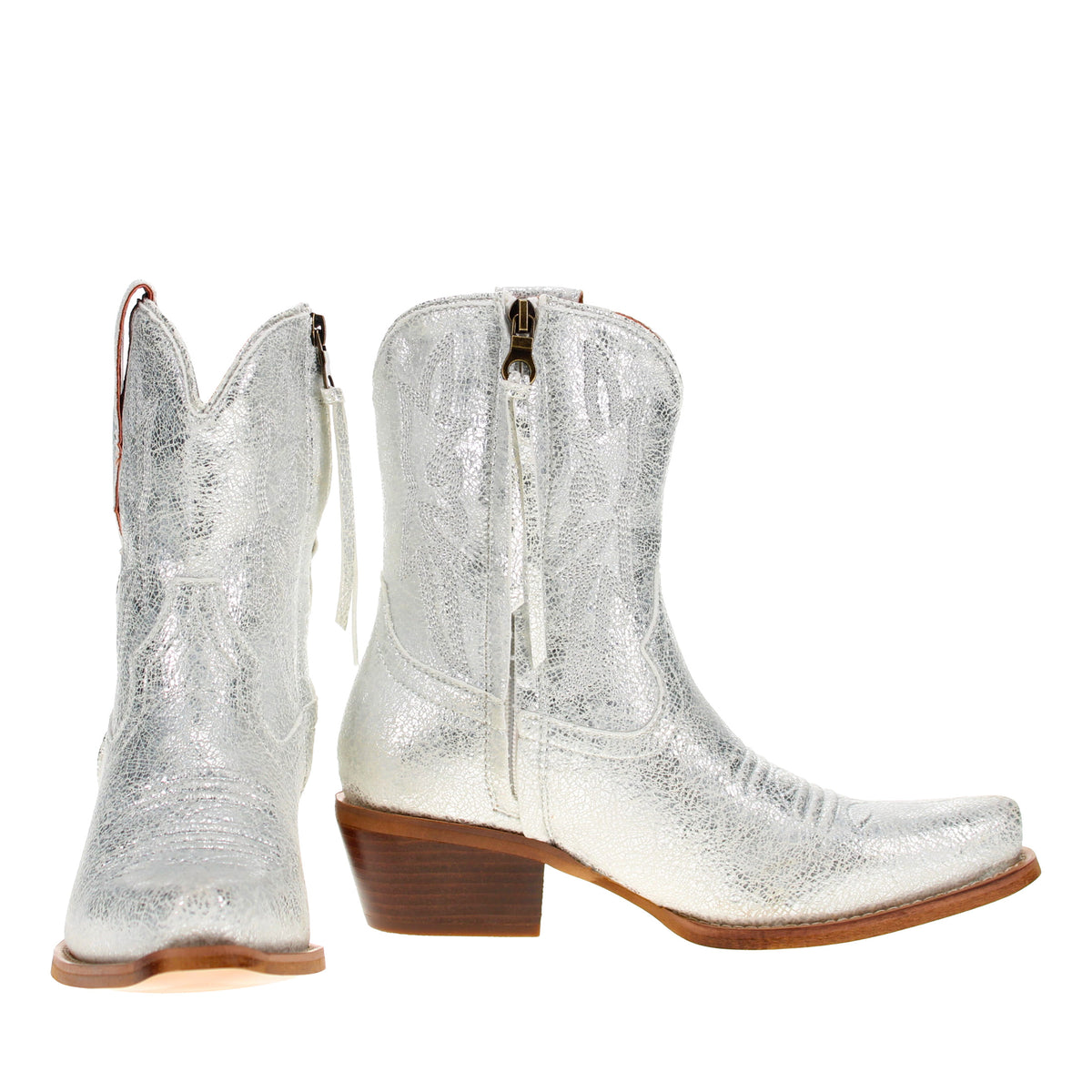 Pair of silver cowboy boots with side zippers, low block heels, tan welt