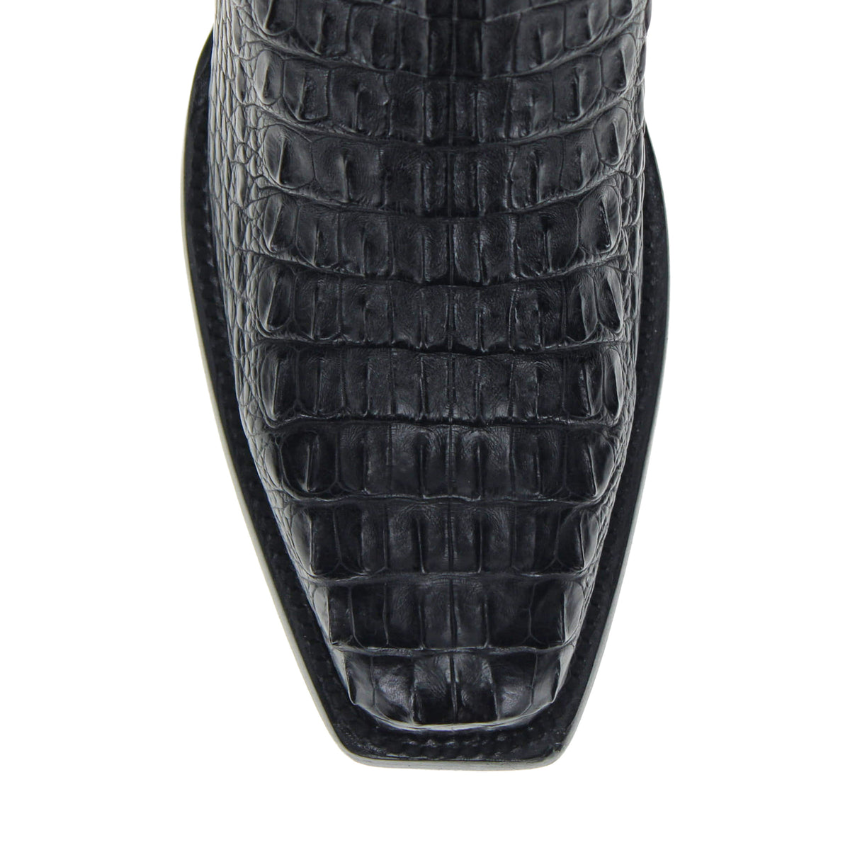 Close-up of black boot toe and vamp with embossed crocodile-style texture.