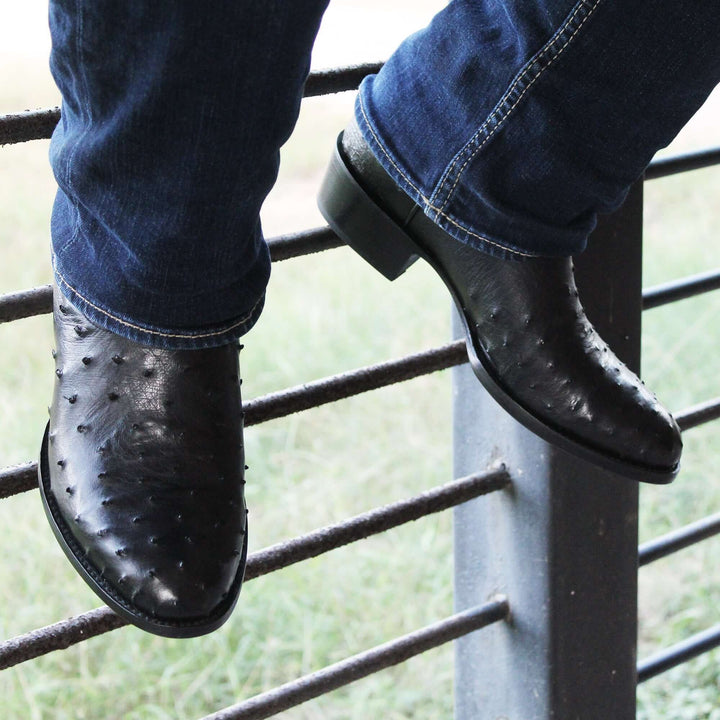 Mens black leather western boots with round toe and decorative stitching, featuring full-quill ostrich leather on the foot for added texture.