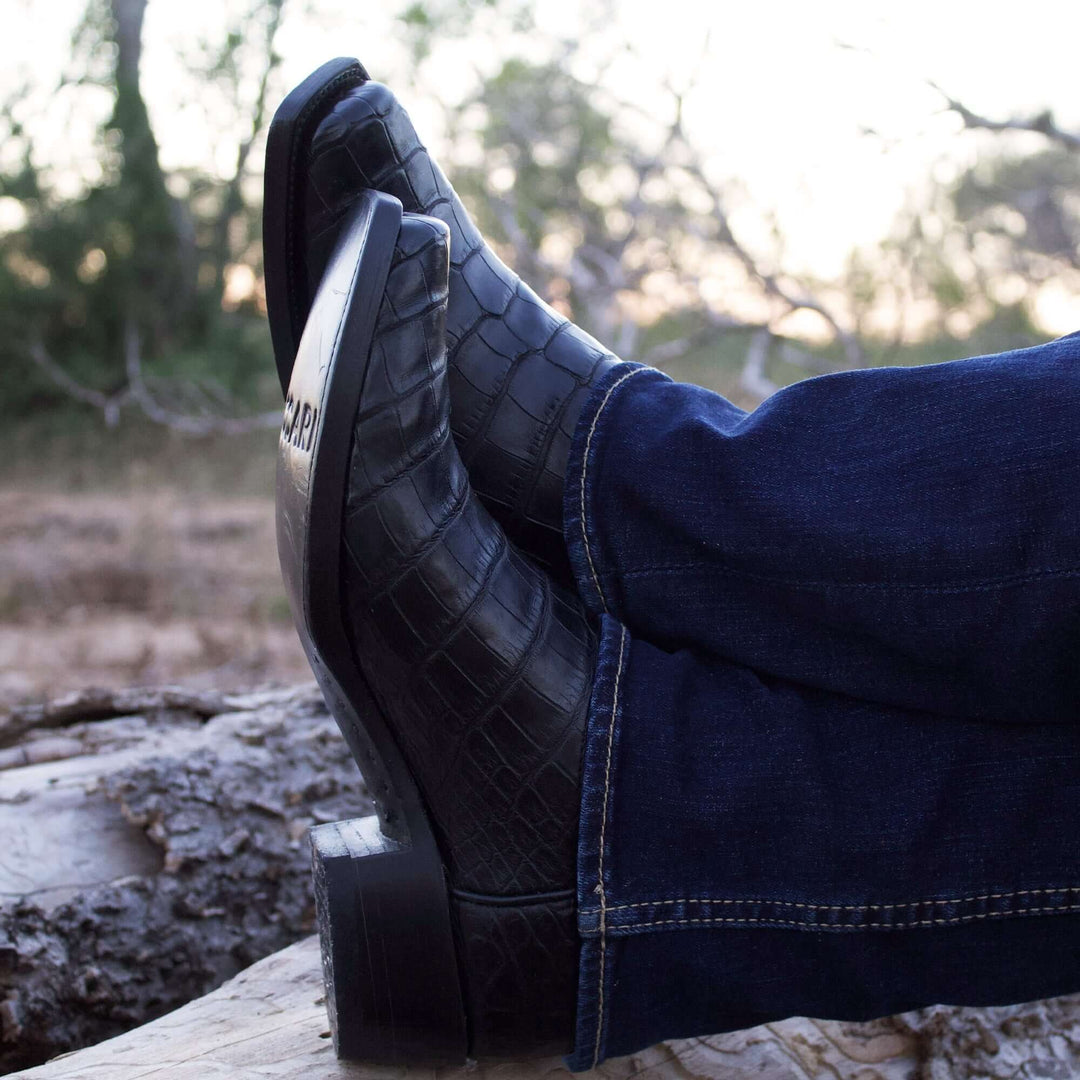 Pair of black alligator cowboy boots with caiman crocodile texture