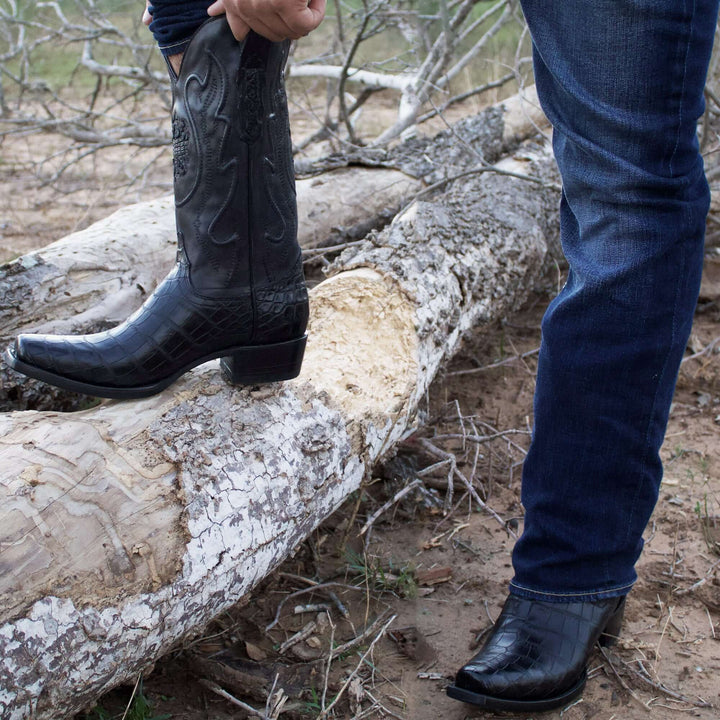Pair of black alligator cowboy boots with caiman crocodile texture