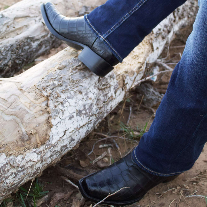 Pair of black alligator cowboy boots with caiman crocodile texture