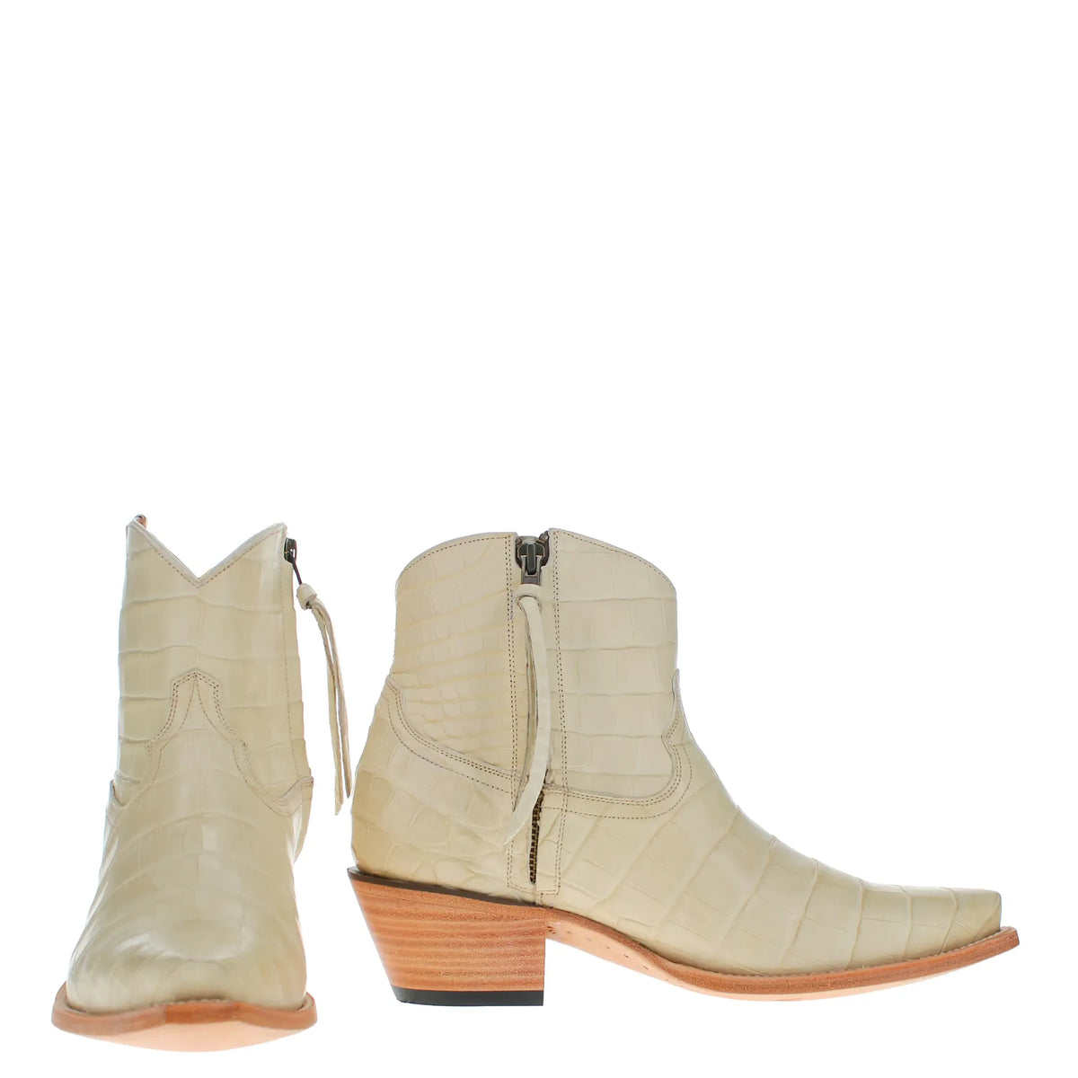 A pair of ivory alligator belly western ankle boots featuring side zippers, square toes, and stacked wood-look heels, shown against a plain white background.