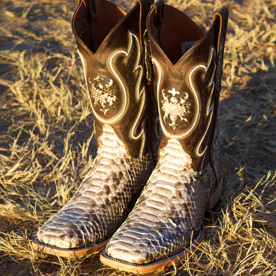 Mens black leather western boots with round toe and decorative stitching, featuring full-quill ostrich leather on the foot for added texture.