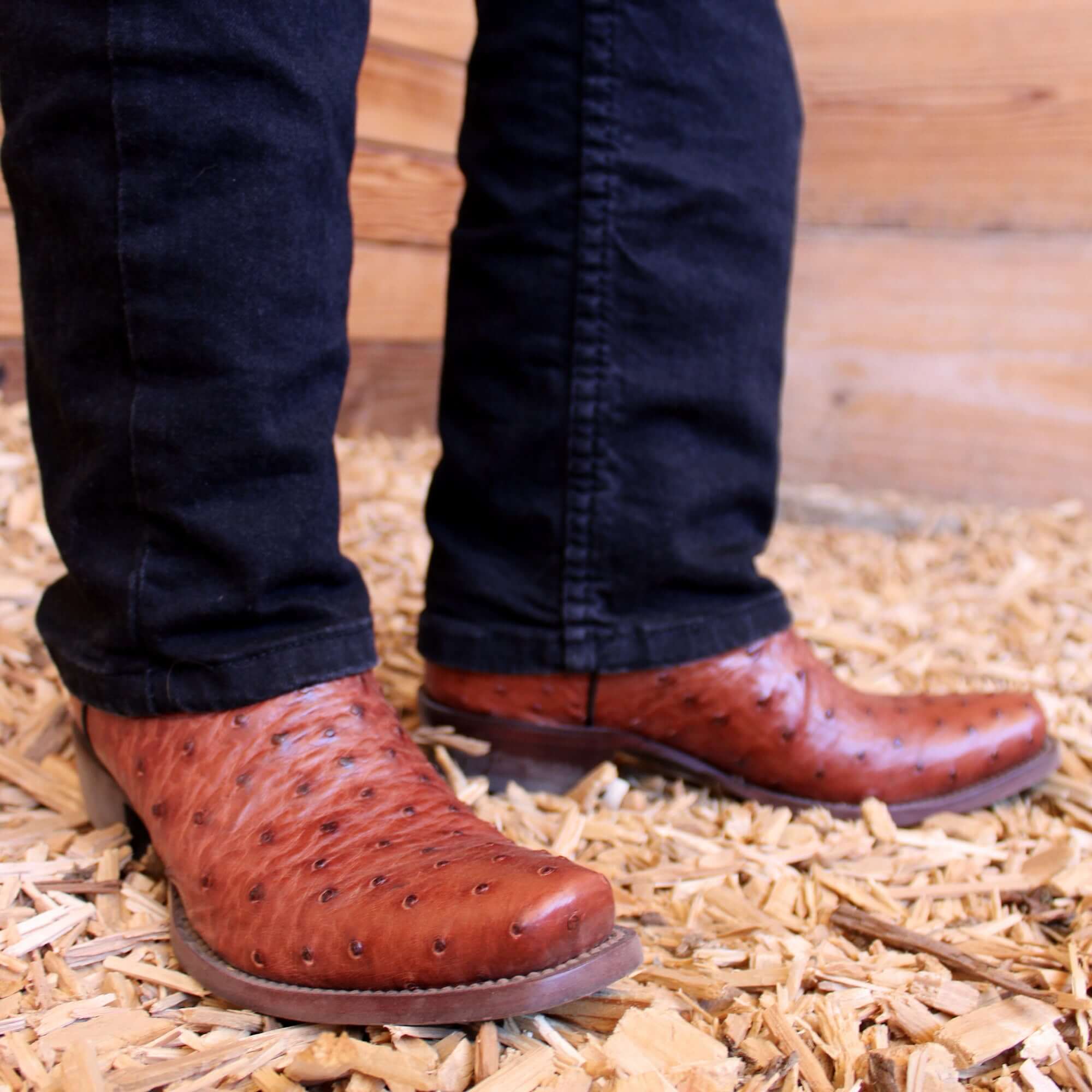 Mens congac leather western boots with narrow square toe and decorative stitching, featuring full-quill ostrich leather on the foot for added texture.