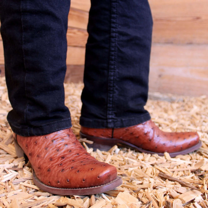 Mens congac leather western boots with narrow square toe and decorative stitching, featuring full-quill ostrich leather on the foot for added texture.