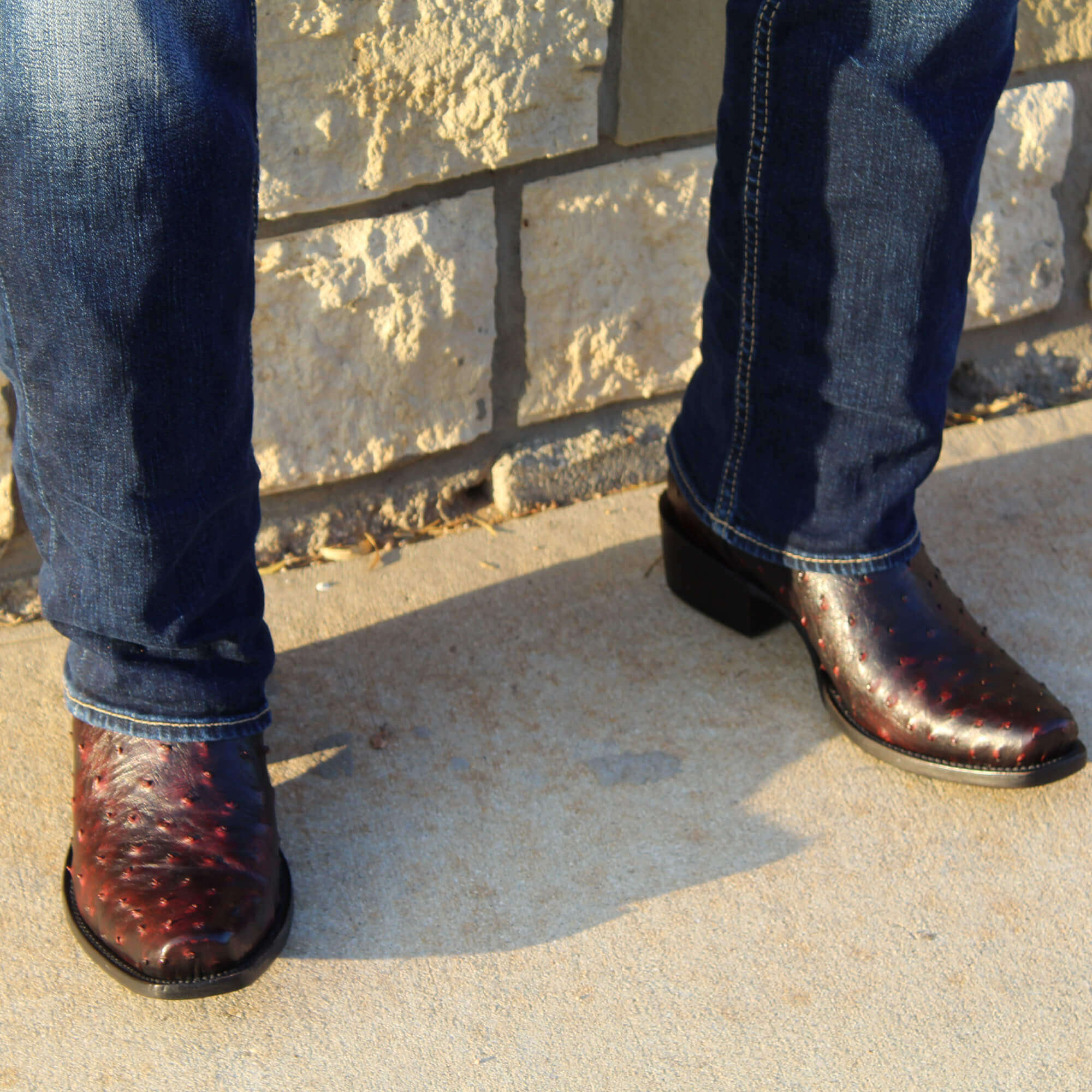 Mens black cherry leather western boots with narrow square toe and decorative stitching, featuring full-quill ostrich leather on the foot for added texture.