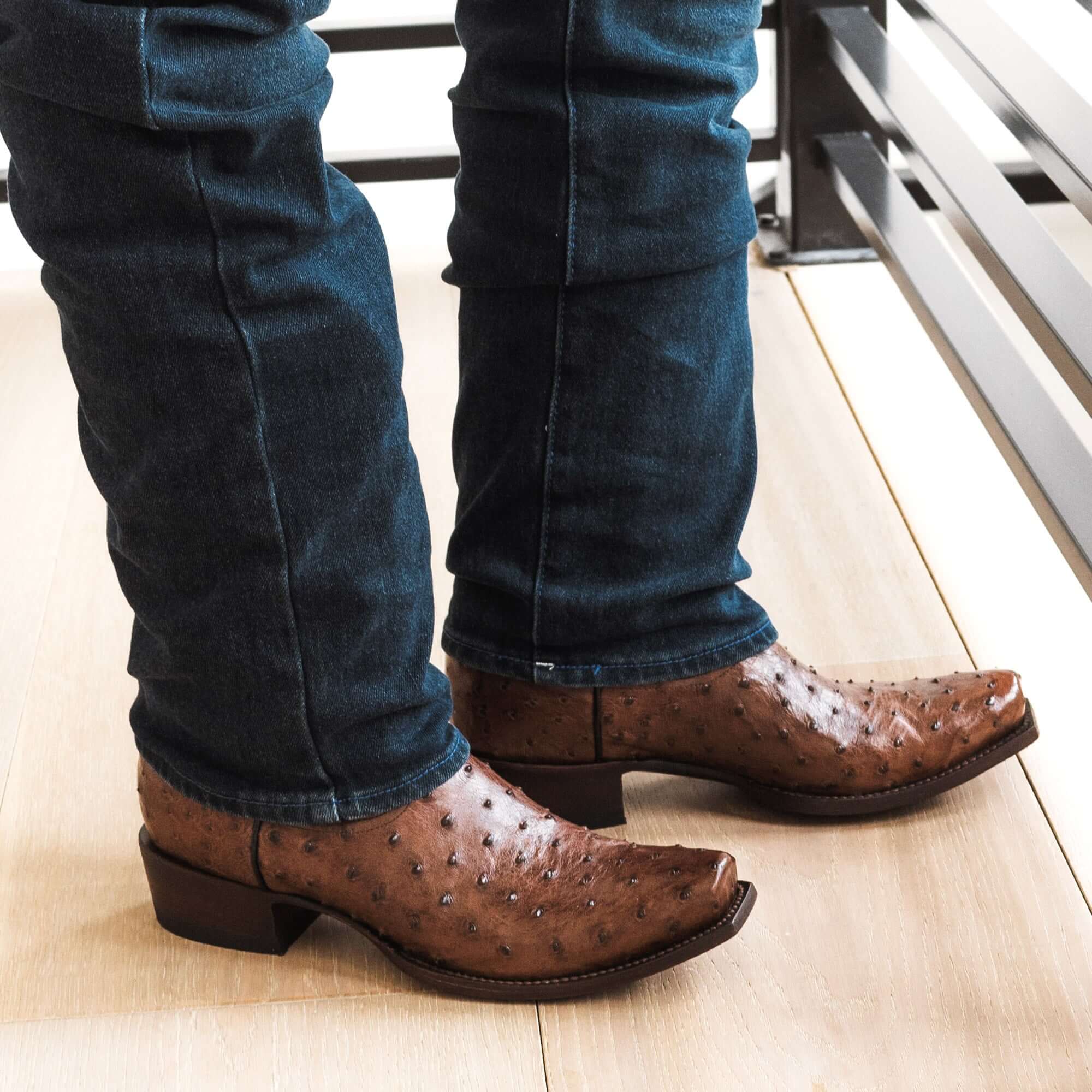 Mens mocha leather western boots with narrow square toe and decorative stitching, featuring full-quill ostrich leather on the foot for added texture.