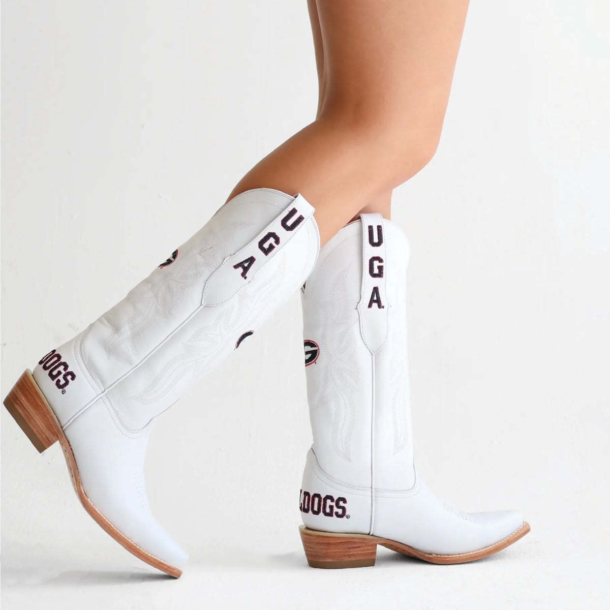 White cowboy boots, angled view, brown heel and shaft patches with UGA lettering