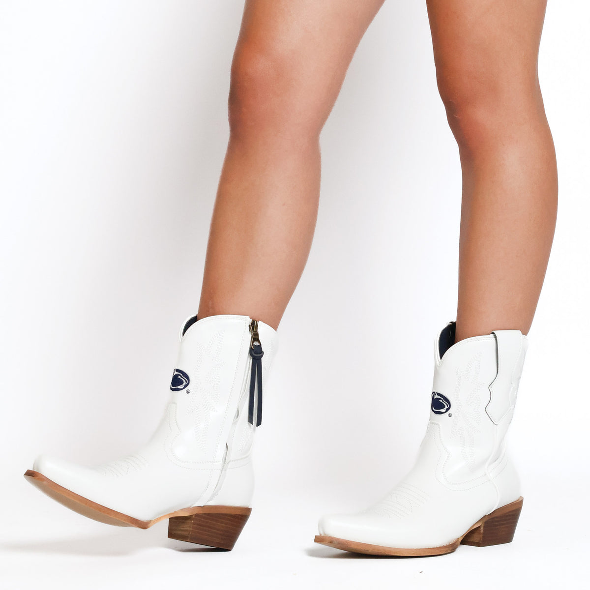 Lynn white cowboy boots with dark blue oval logo and stacked wood-tone heel
