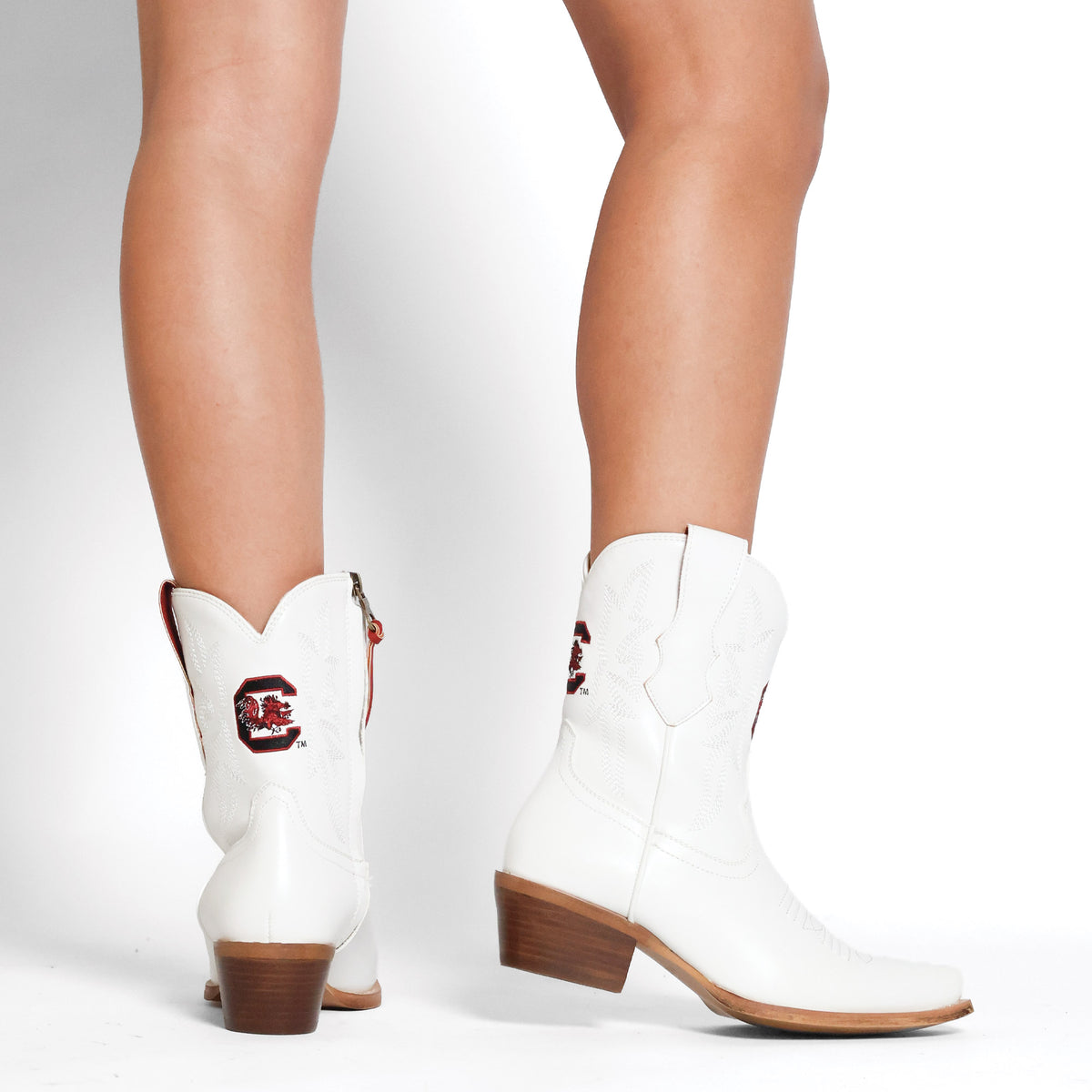 White cowboy boots with red badge, ankle height, stacked wood heel